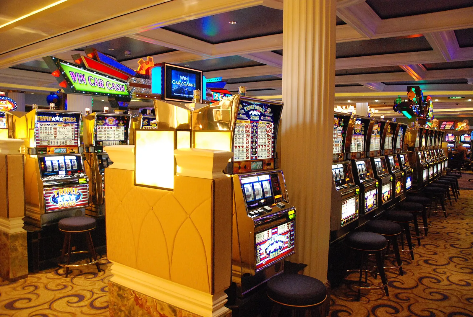Rows of slot machines on a cruise ship casino floor, where tier credits are earned
