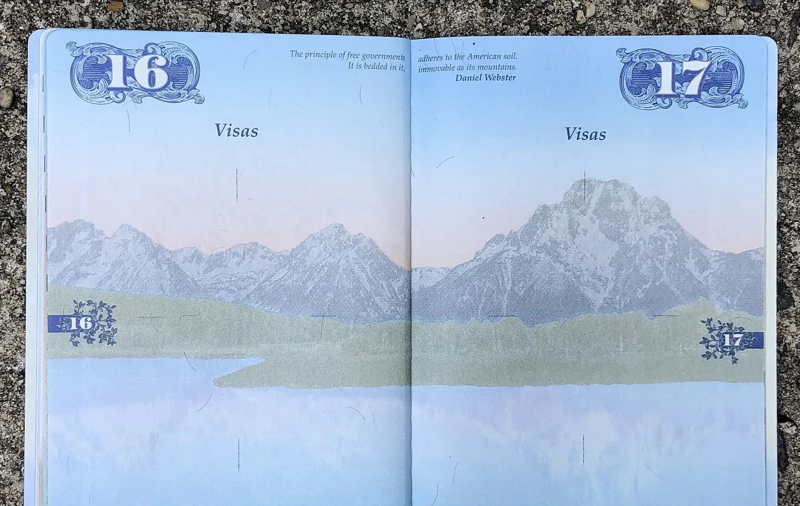 The empty visa pages of a United States passport, open on a table