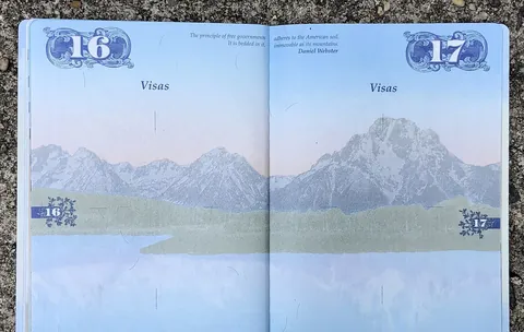 The empty visa pages of a United States passport, open on a table